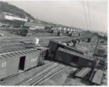 Accident on Interbay yard south lead tracks, at &quot;NP Crossing&quot;, NP tracks cross GN from left-to-right to access industries and Navy docks. Small NP yard at left in front of barracks; NP semaphore visible at right. &quot;G yard&quot; in distance. Likely mid-60&#39;s.