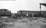 Cleanup of head on collision between local and standing through freight.