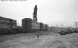 Cleanup of head on collision between local and standing through freight.