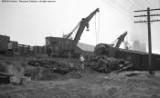 Cleanup of head on collision between local and standing through freight.