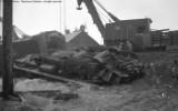 Upside down frame of RS3. Cleanup of head on collision between local and standing through freight.