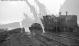 Cleanup of head on collision between local and standing through freight.