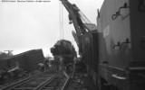 Cleanup of head on collision between local and standing through freight.